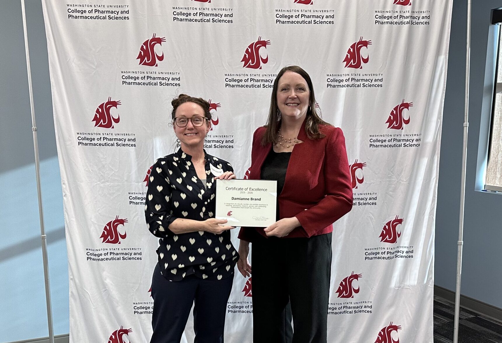 Damianne Brand receiving Faculty Excellence Award from Interim Dean Julie Akers
