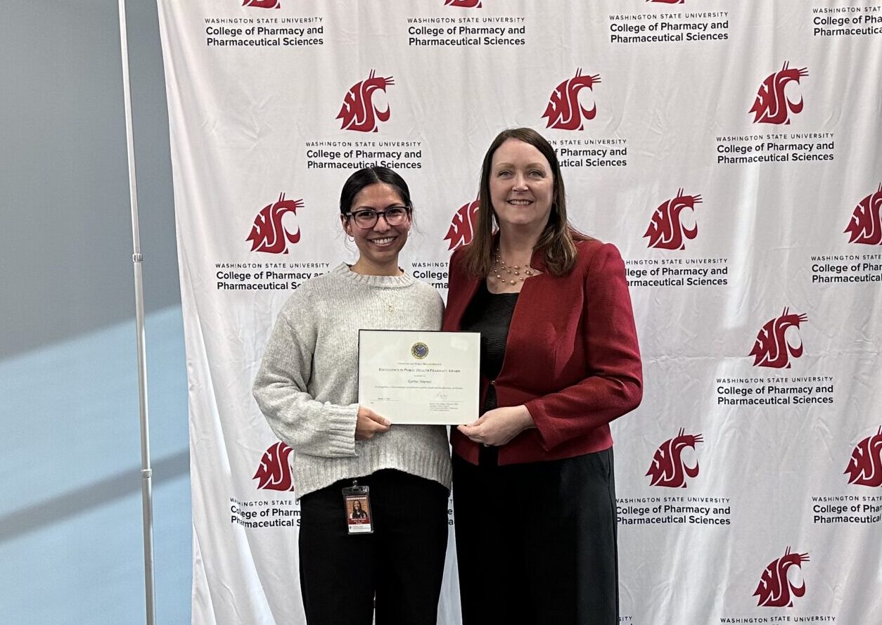 Karina Jimenez receiving U.S. Public Health Service Excellence in Public Health Pharmacy award from Interim Dean Julie Akers