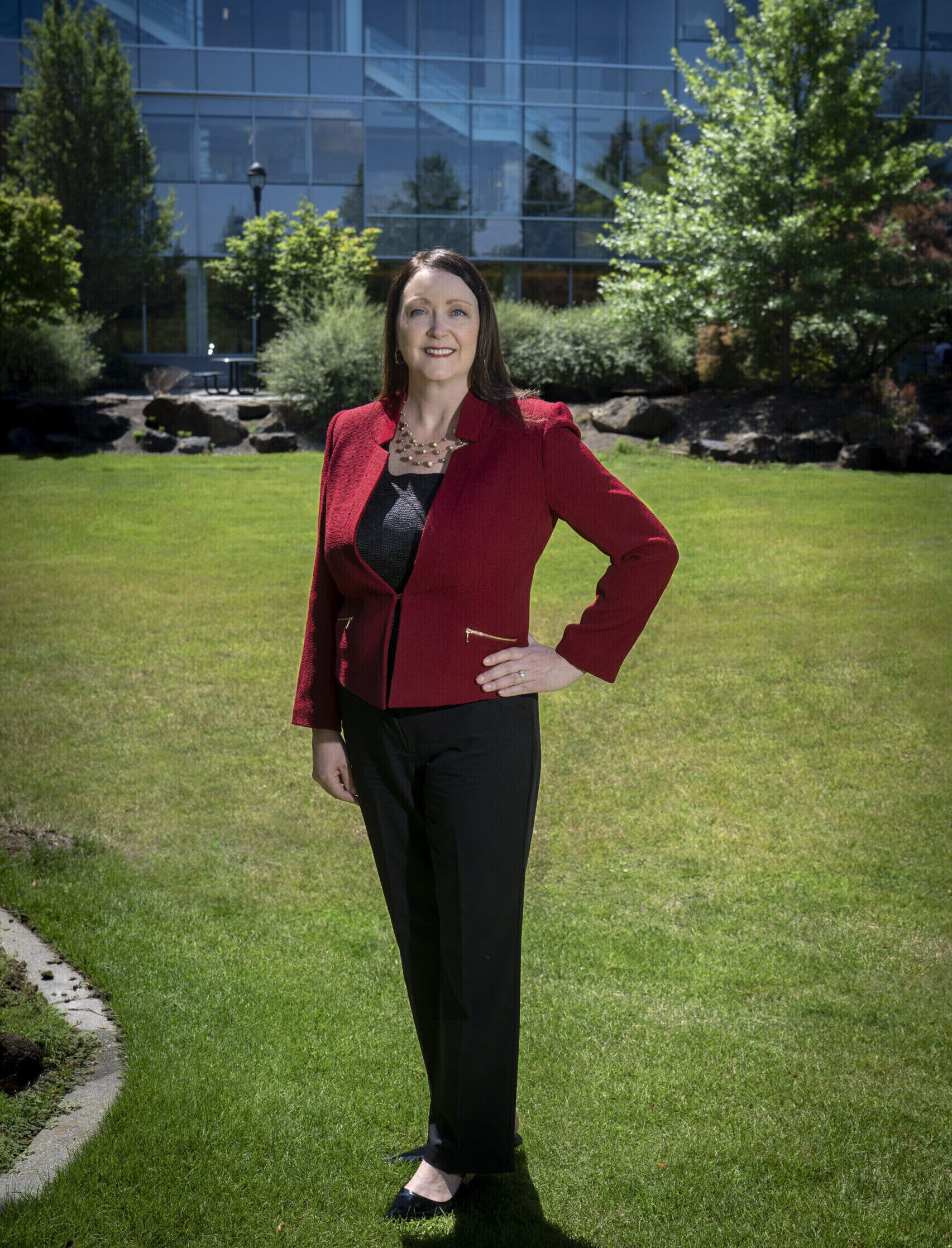 Julie Akers poses in front of the Pharmaceutical and Biomedical Sciences building