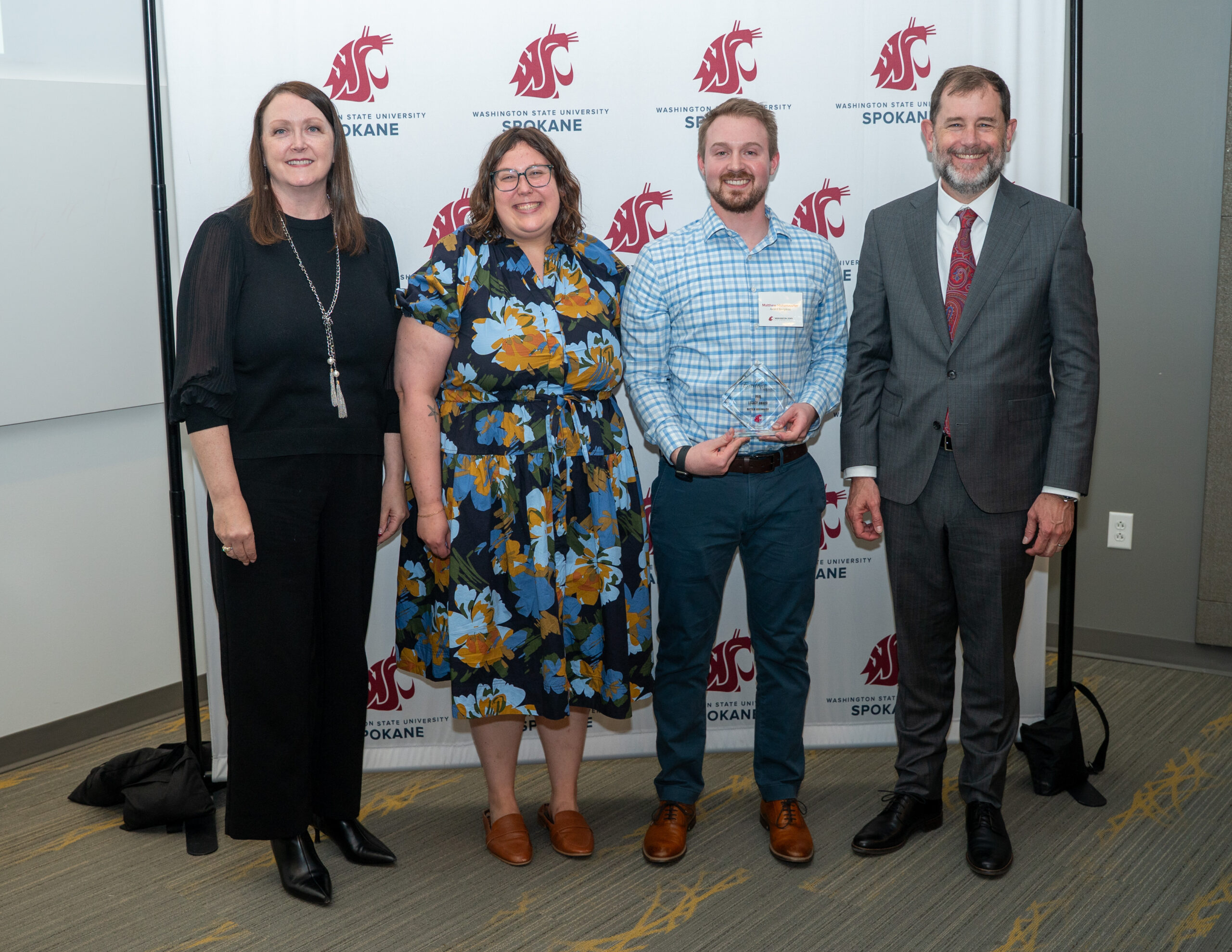 Matthew Hohenwalter holding Health Sciences Student Legacy Award alongside Interim Dean Julie Akers, Academic and Student Success Advisor Hannah Green, and Provost Chris Riley-Tillman