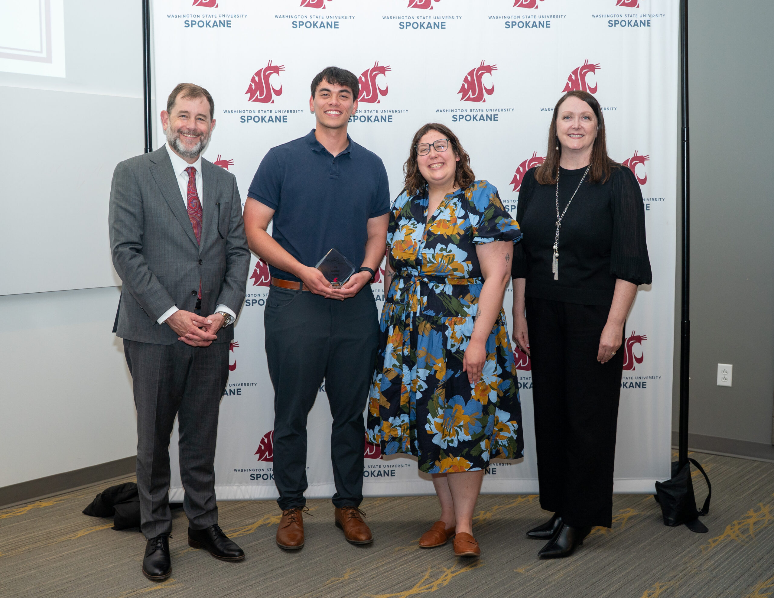 Drexler Yesiki holding Health Sciences Student Leadership Award alongside Provost Chris Riley-Tillman, Academic and Student Success Advisor Hannah Green, and Interim Dean Julie Akers