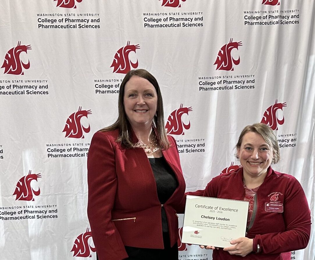 Chelsey Loudon receiving staff excellence award from Interim Dean Julie Akers