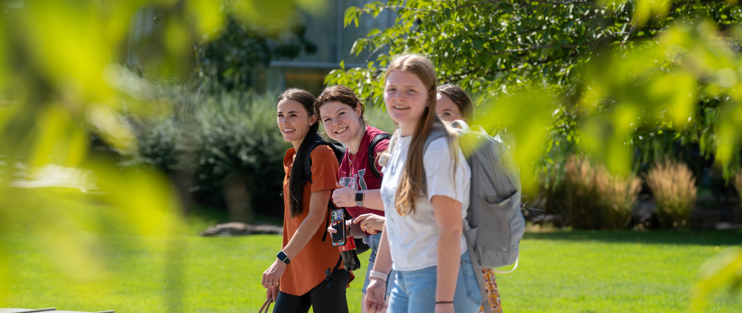 Pharmacy students walk across campus on a sunny August day during orientation week