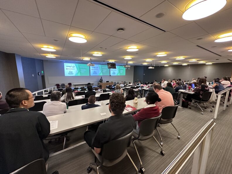 Industry Advisory Board members, faculty and students in an auditorium watching the keynote speaker.