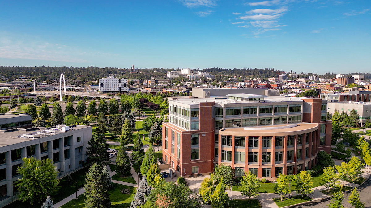 High, wide-angle view of the southern side of the academic center with view of the surrounding areas of campus