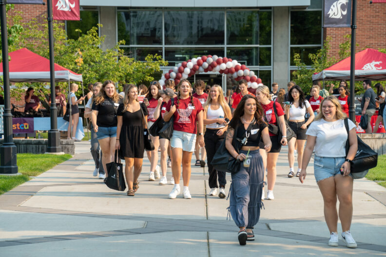 Students attending campus orientation walking on campus