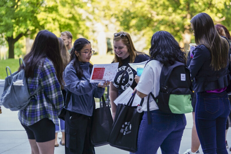 WSU Spokane campus orientation employee helping students during Campus Orientation Day