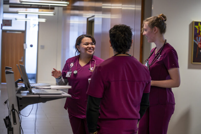 Nursing students working in simulation space