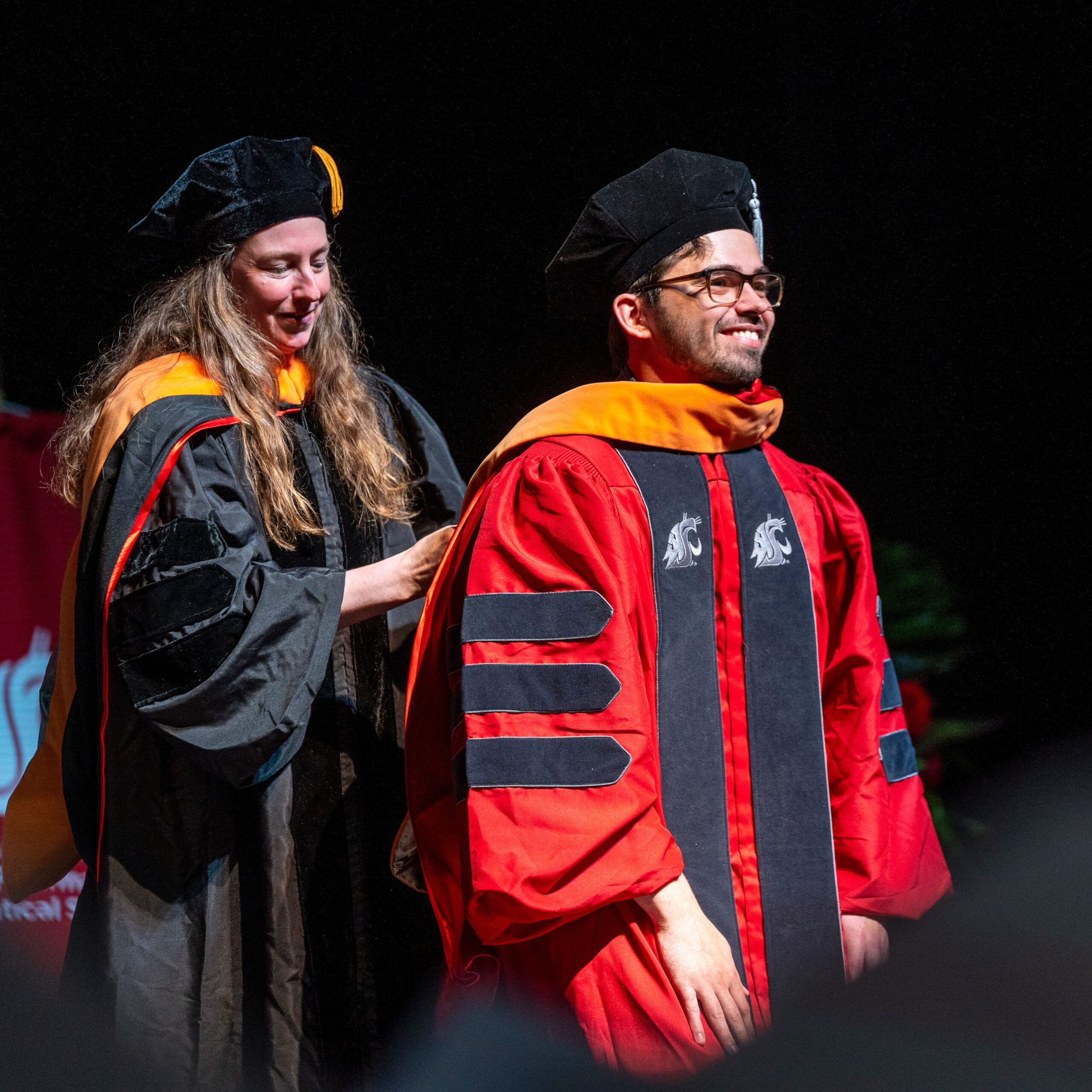 College of nursing student being hooded during graduation ceremony