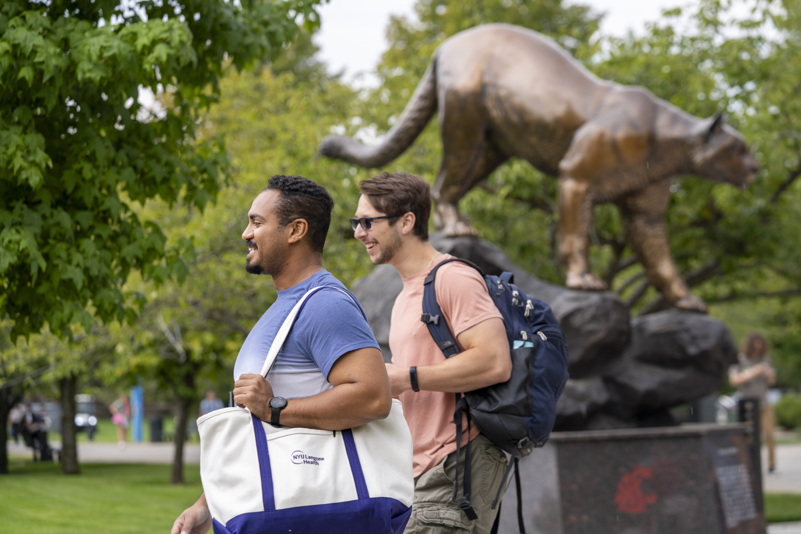 students walking on campus outside of the academic center