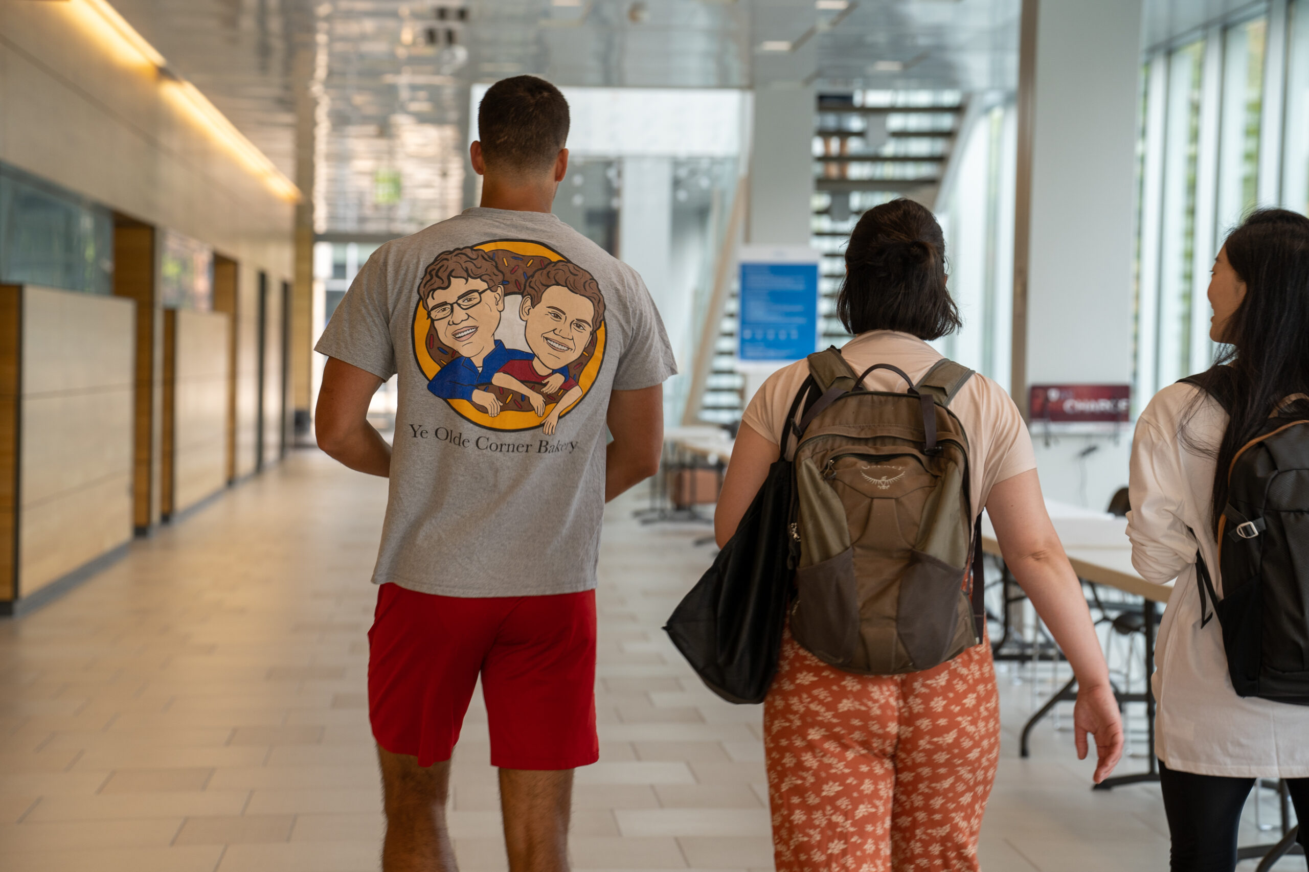student walking away from camera inside of pharmacy building