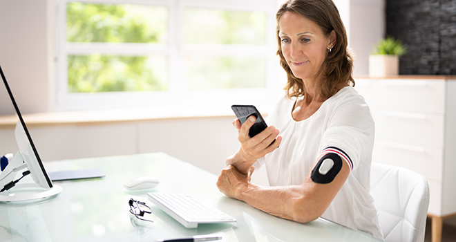 Continuous Glucose Blood Check Using Smartphone. Patient With Diabetes