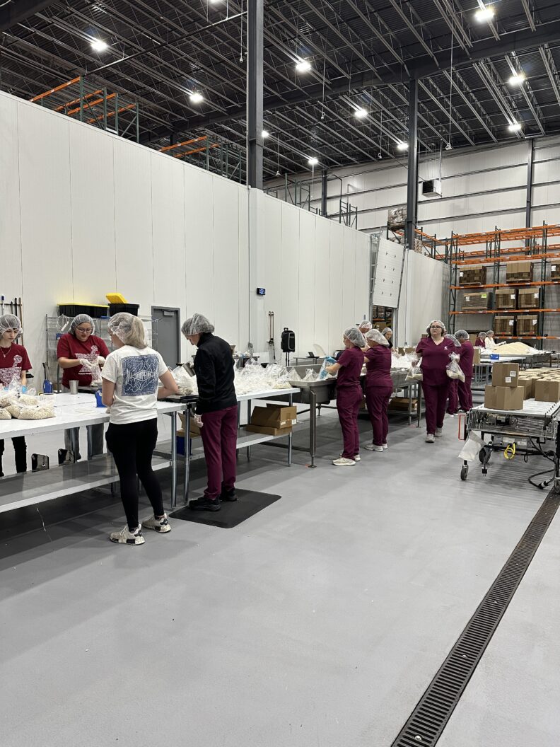 Students assist with sorting and packaging food at Northwest Harvest Food Bank in Yakima, Wash.