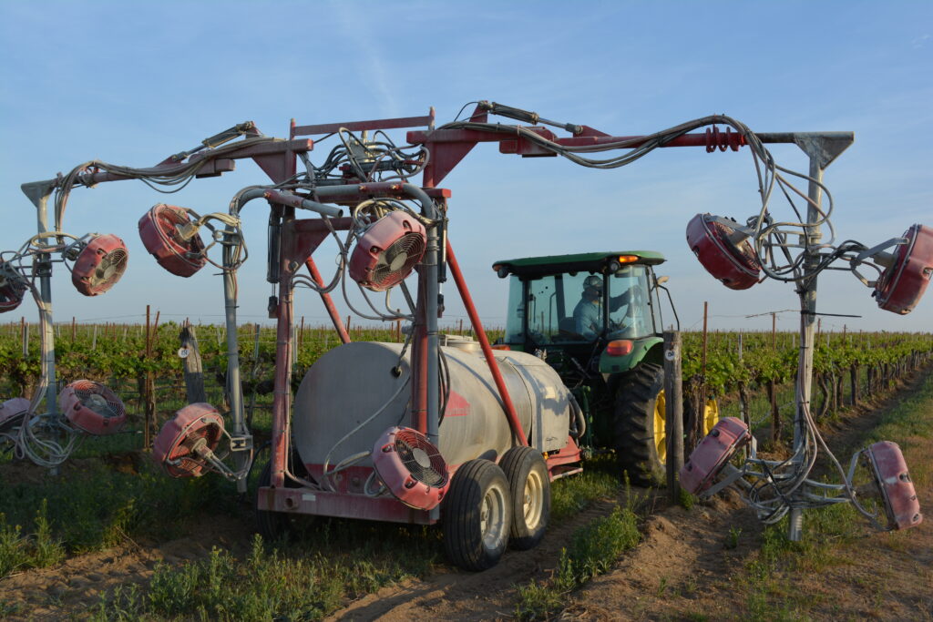 Multi-head axial sprayer in a vineyard. Photo by Margaret McCoy. 