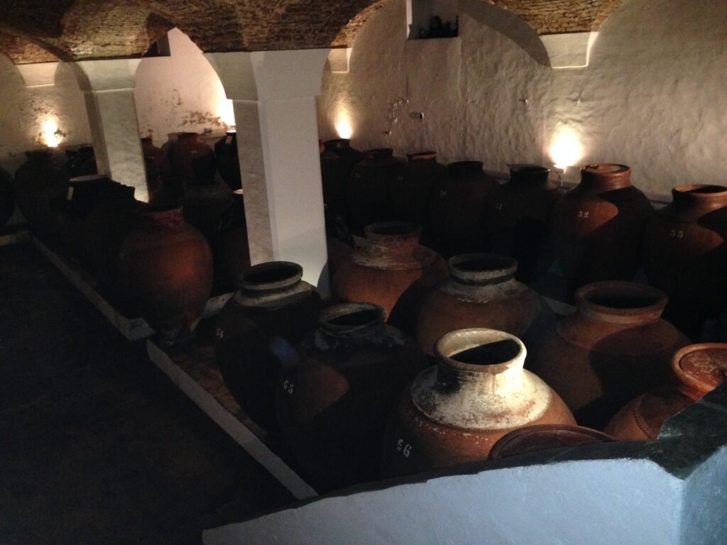 Old large clay winemaking jars in a cellar