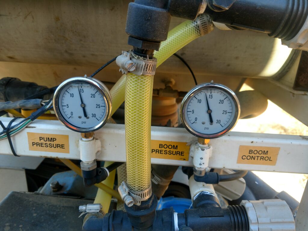 Close-up of two pressure gauges on a sprayer.
