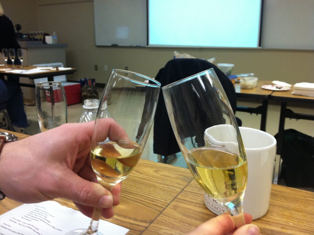 Two glasses of bubble wine clinking together