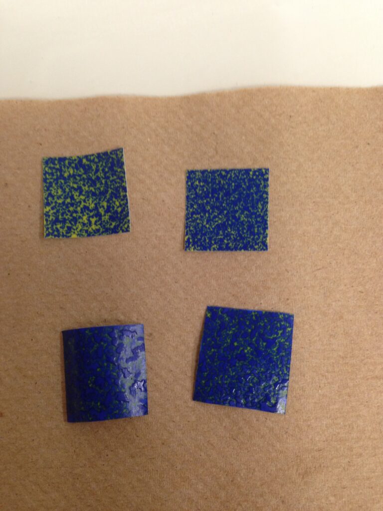 Yellow water sensitive paper that has turned blue due to moisture exposure