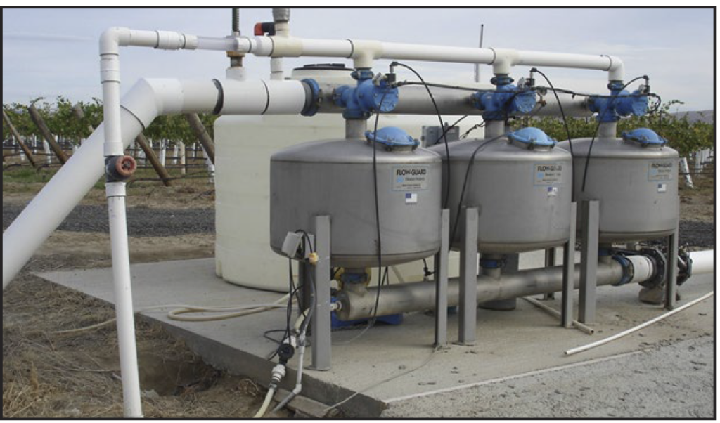 A series of three tanks in a vineyard water filtration system.