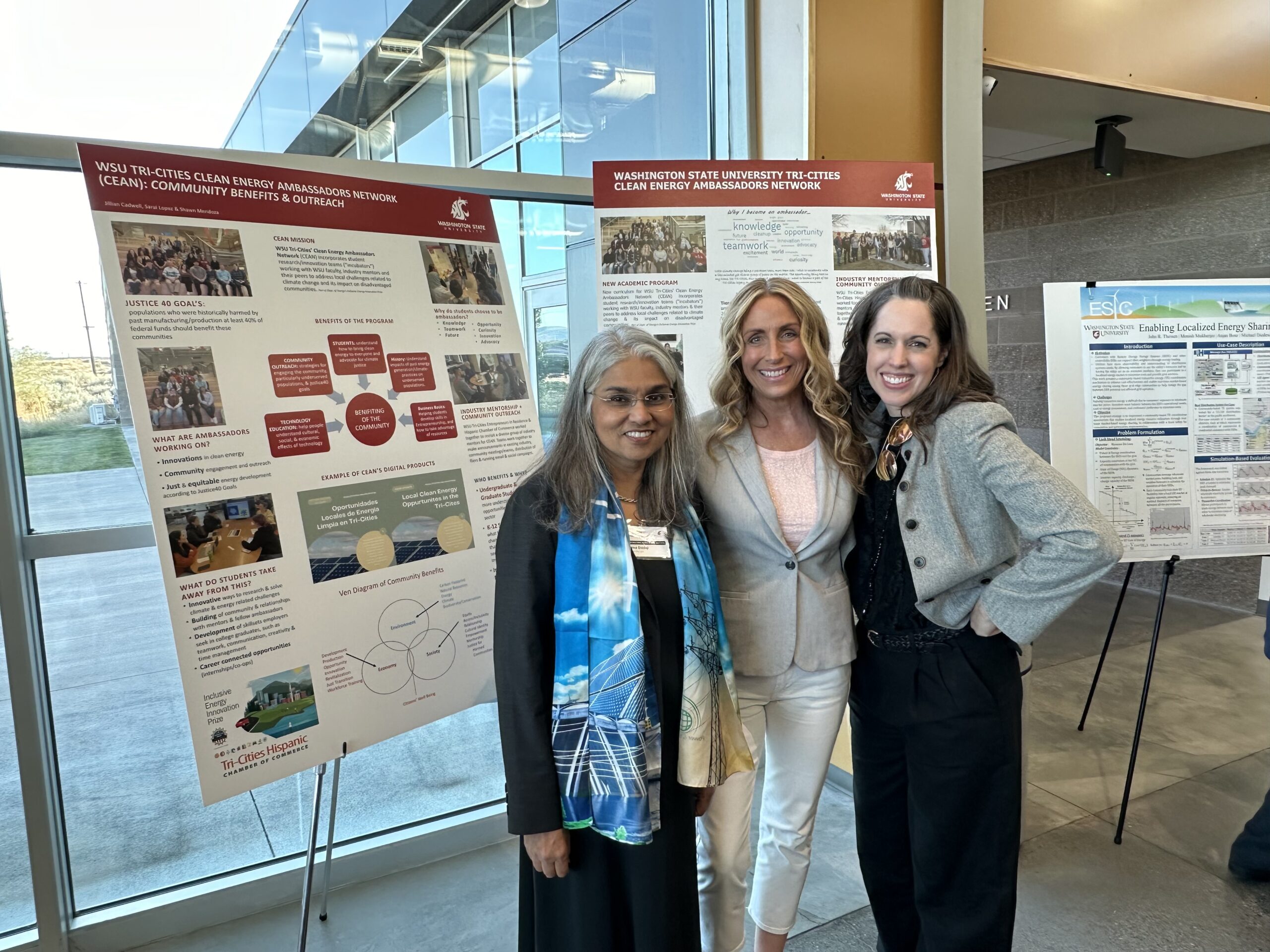 Uzma Saddiqi, Stephanie Barnard and Jillian Cadwell stand in front of Jillian's posters.
