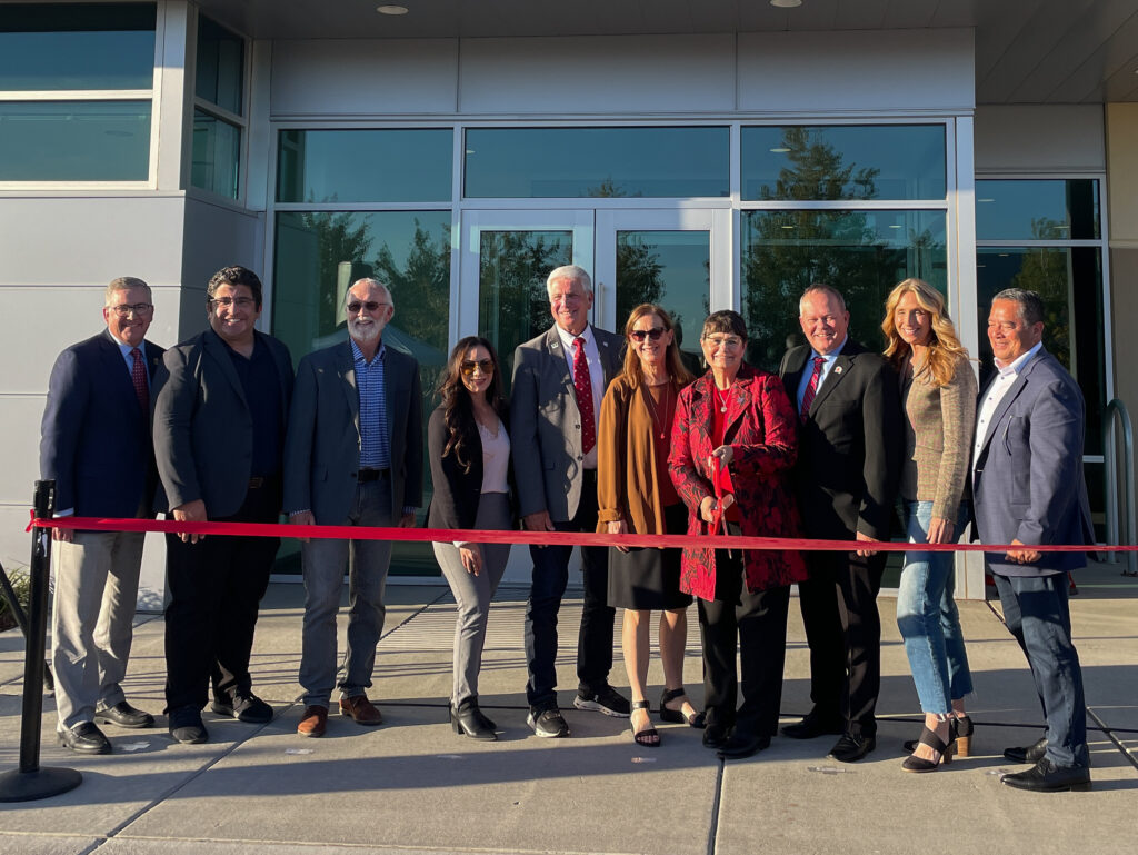 Washington State University President Kirk Schulz, Central Washington Outreach Director from the Office of U.S. Senator Maria Cantwell Richard Evans, Congressman Dan Newhouse, WA State Senator Nikki Torres, WA State Senator Perry Dozier, WSU Tri-Cities Chancellor Sandra Haynes, INEF Inaugural Director and Bob Ferguson Endowed Professor Noel Schulz, WA State Senator Matt Boehnke, WA State Legislative Rep. Stephanie Barnard and WA State Legislative Rep. Alex Ybarra posing with scissors at the ribbon cutting.