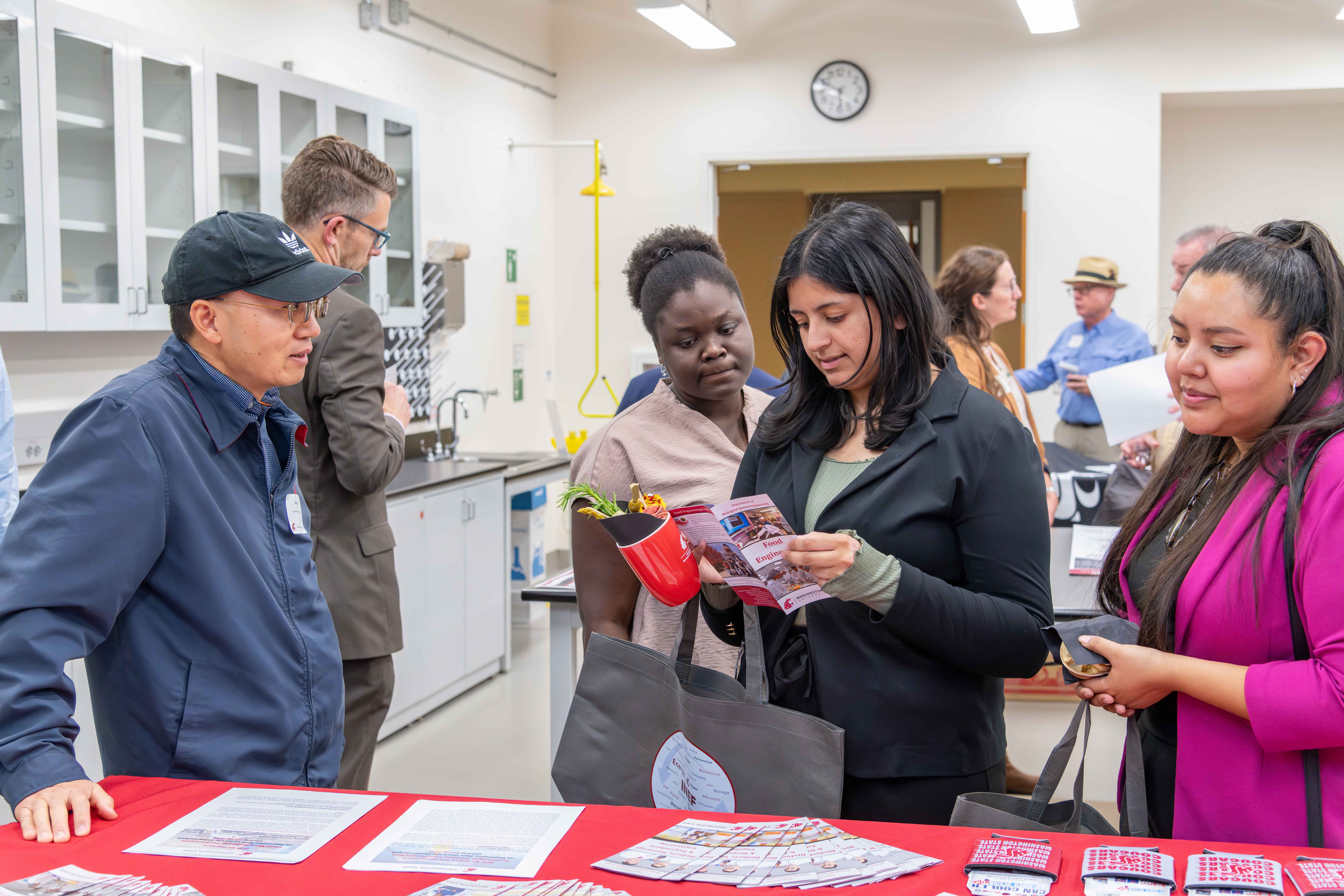 CEAN student ambassadors looking at a pamphlet.