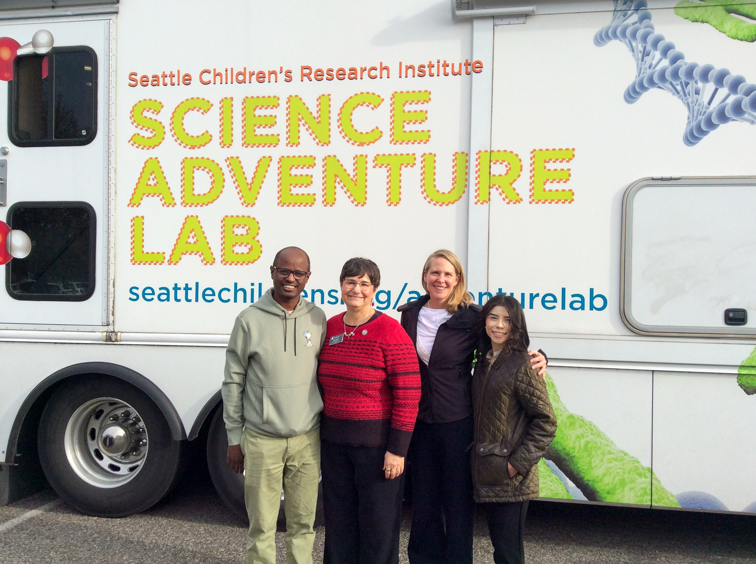  L-R Yonas Demissie, INEF Assistant Director of Engineering & Environment, Noel Schulz, INEF Inaugural Director and Bob Ferguson Endowed Professor, Carmine Hanks, INEF Public Relations & Communications Coordinator, Yasmin Santana, Administrative Assistant to the Director standing in front of the mobile science adventure lab.