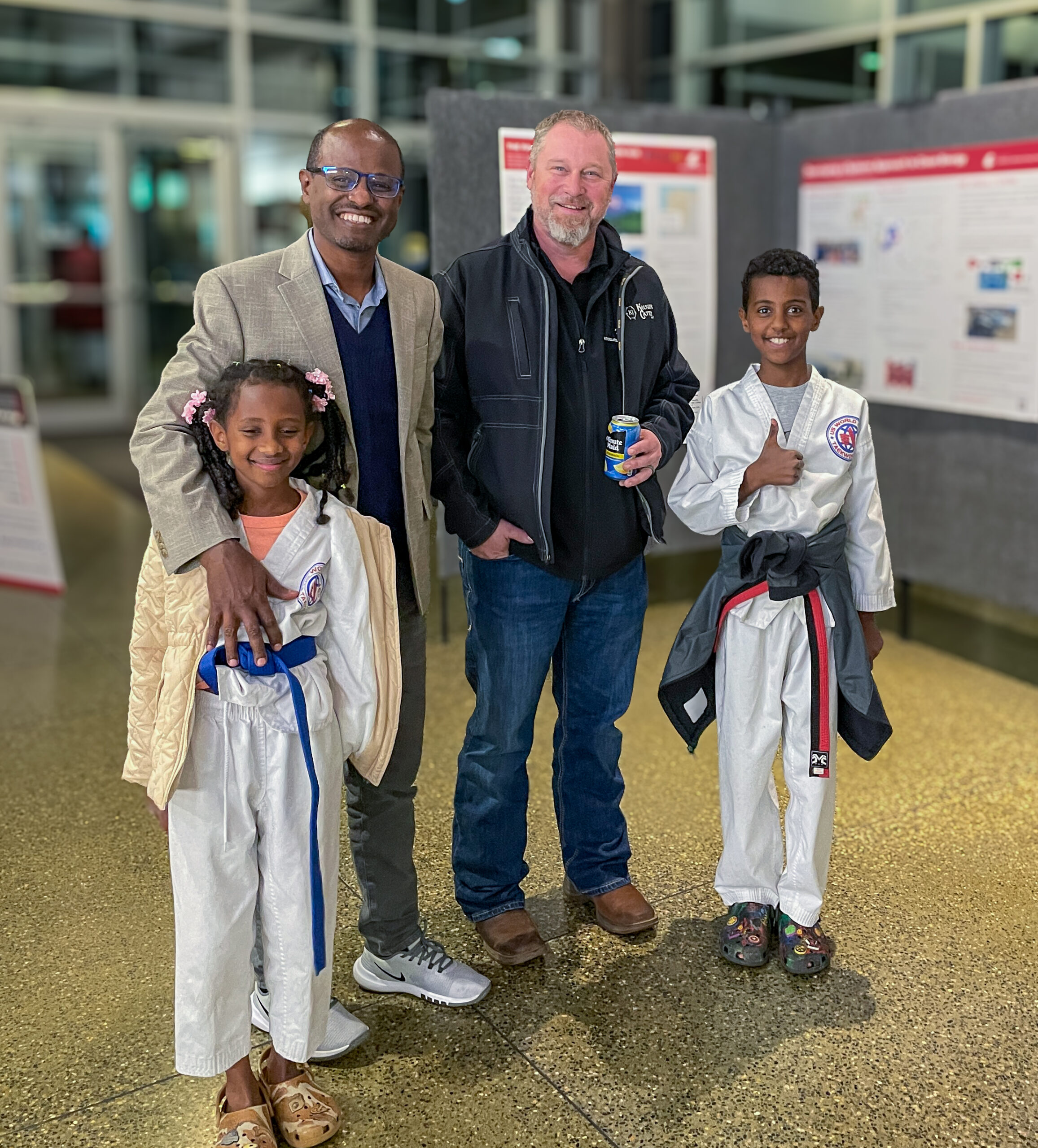 Yonas Demissie, INEF Assistant Director of Engineering & Environment and Chad Kruger, INEF Assistant Director for Agriculture, Extension & Outreach flanked by Yonas' children.