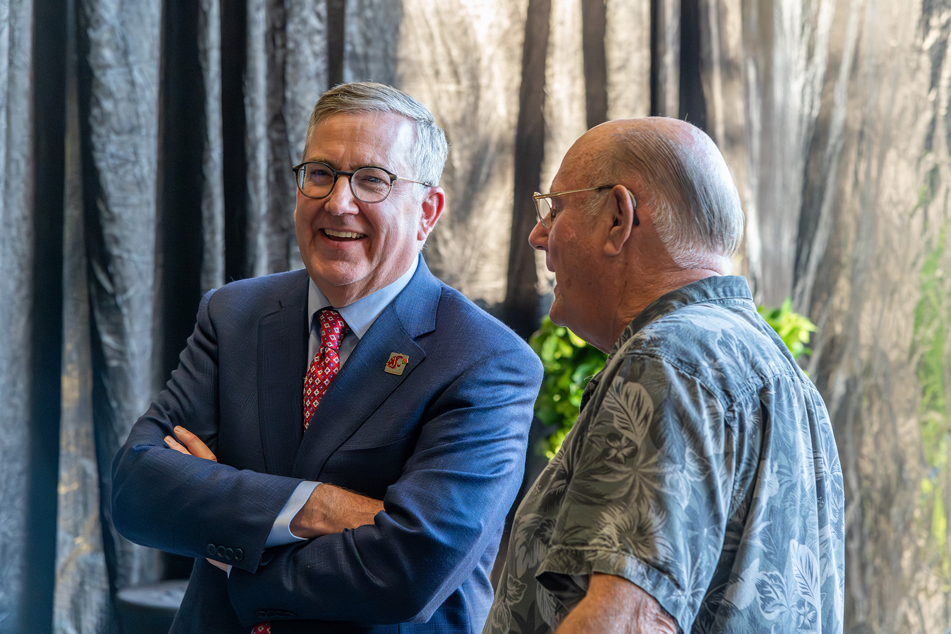 Washington State University President Kirk Schulz talking to an attendee.