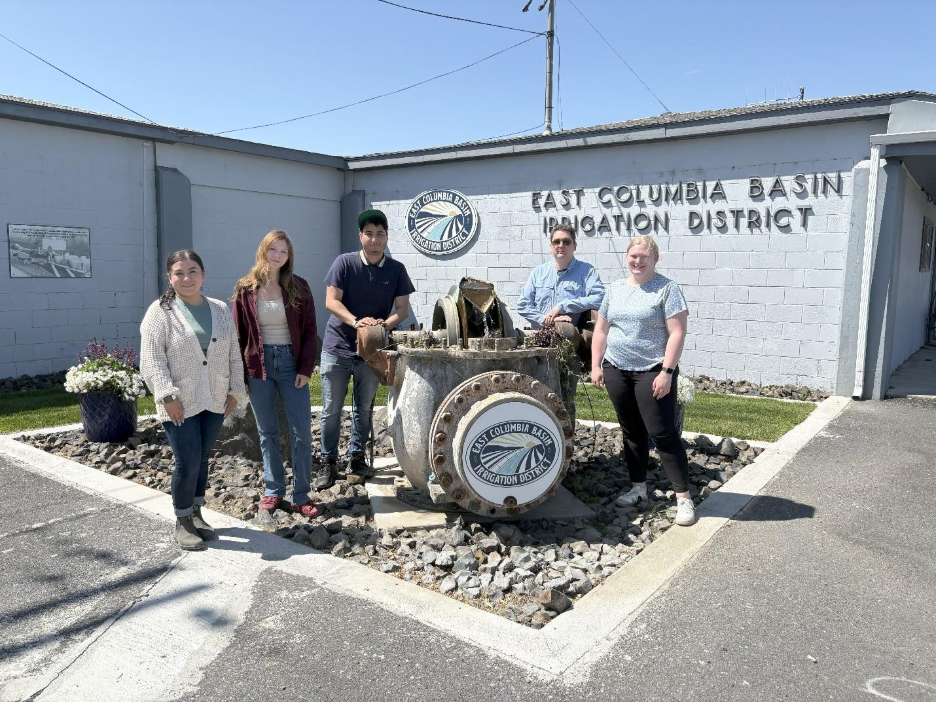 INEF student interns standing next to a building at the Odessa Groundwater Replacement Program site.