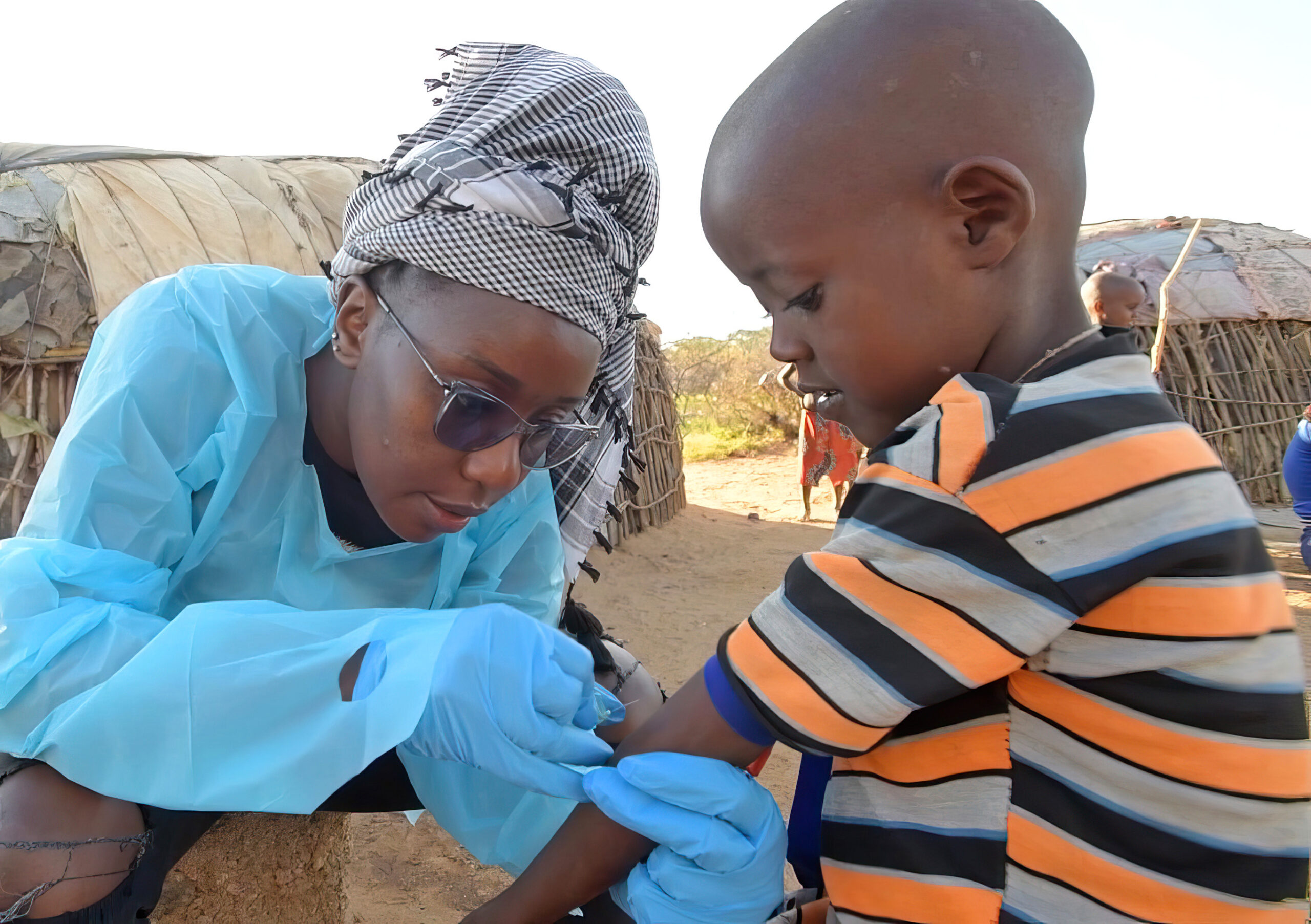 Medical person giving a shot to a child.