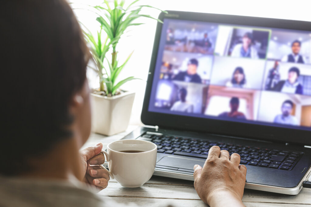 A person using a laptop to attend an online class with multiple participants.