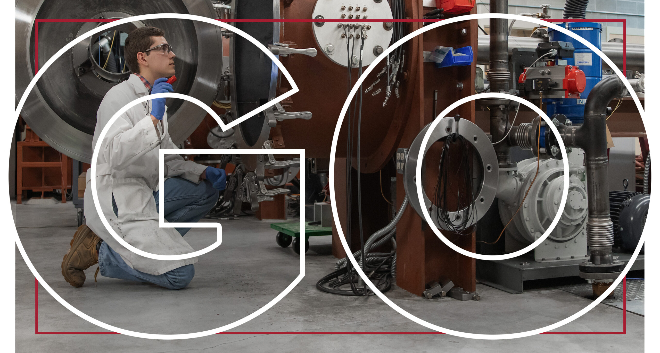 Large text reading Go overlaying a person in safety glasses, a white work coat, and brown work boots kneeling to look inside a large open mechanical device.