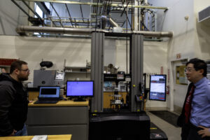 A large industrial load frame or material testing machine inside a WSU Vancouver manufacturing laboratory