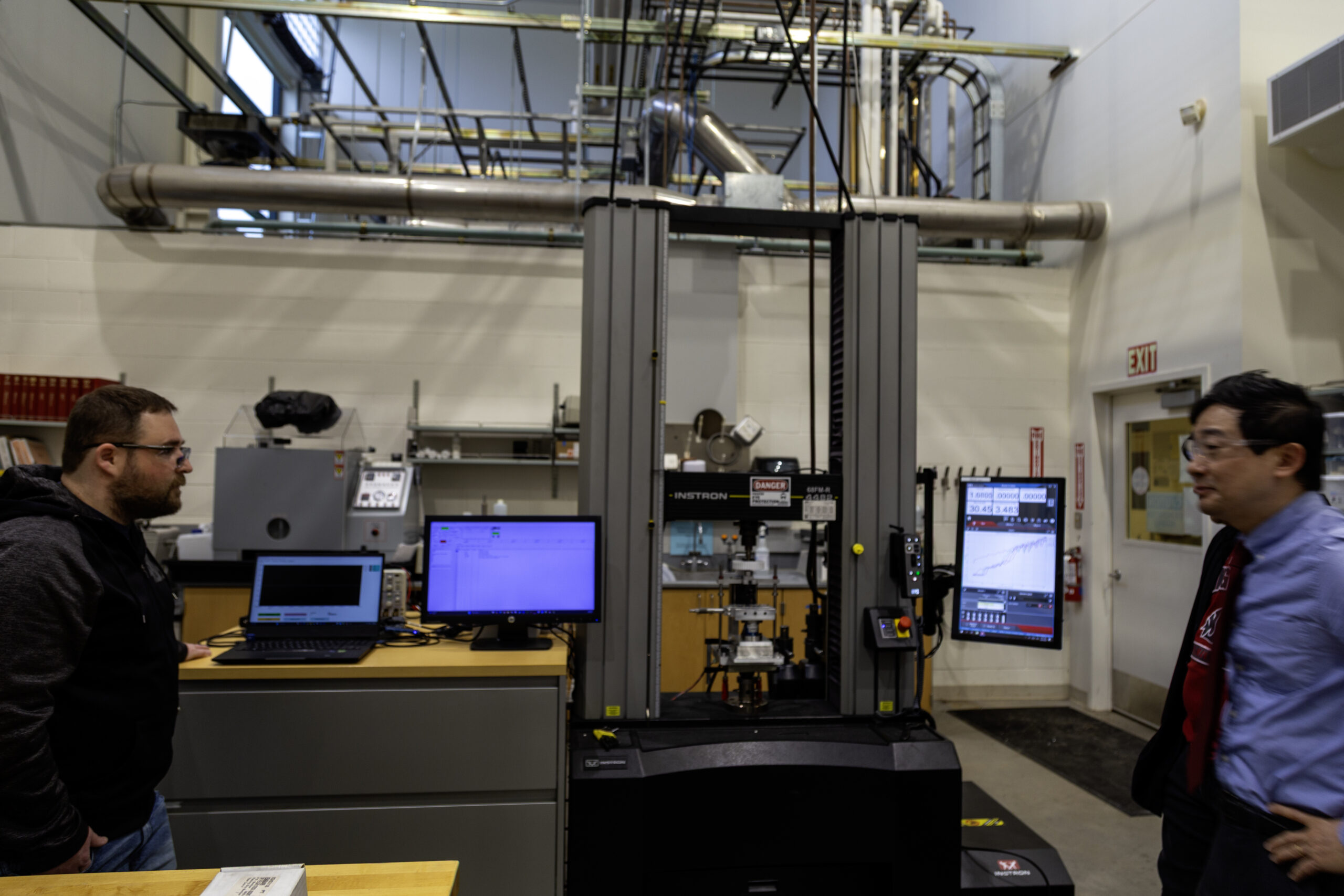 A large industrial load frame or material testing machine inside a WSU Vancouver manufacturing laboratory