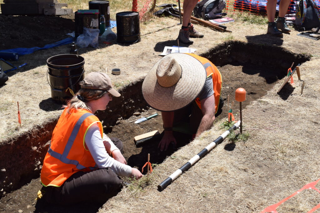 WSU Vancouver anthropology students conducting a field excavation wearing high-visibility vests