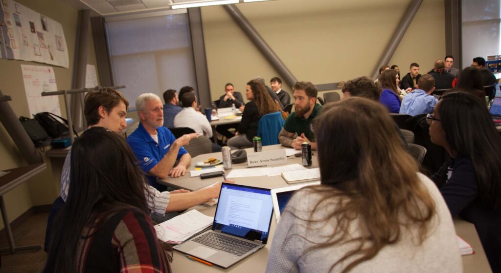 Attendees sitting at tables during a business seminar or conference presentation at WSU Vancouver
