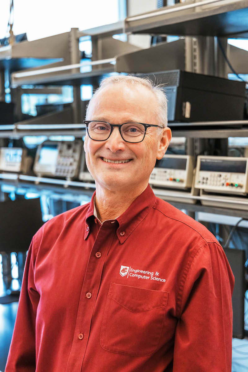 A smiling WSU Vancouver representative wearing a crimson collared shirt indoors