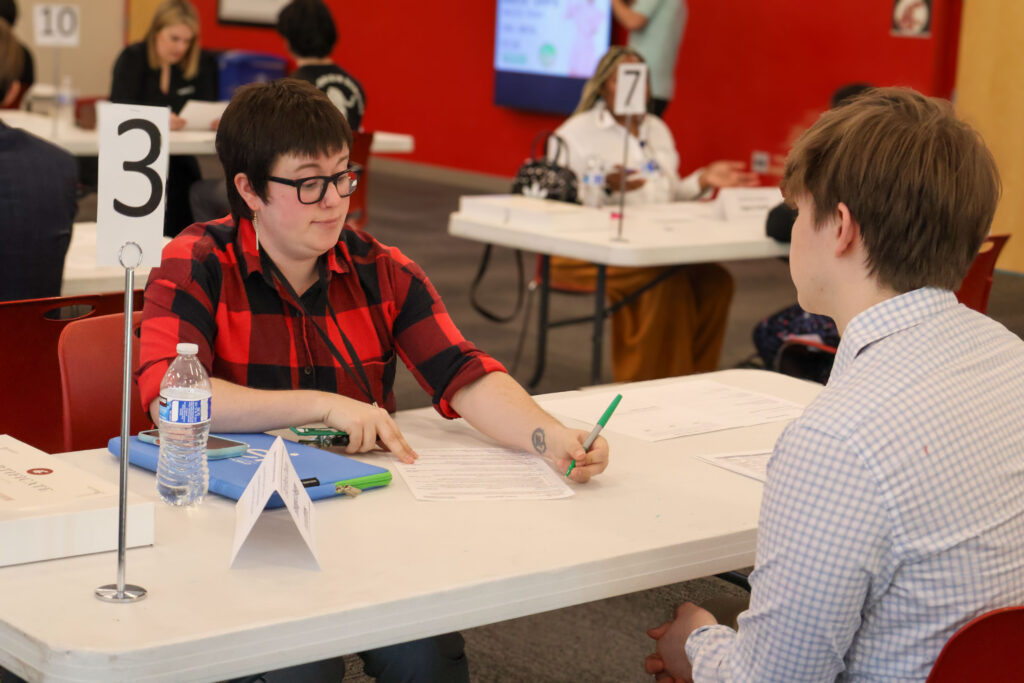 WSU Vancouver-Math Placement Assessment | A group of students working on a hands-on project at a table with an instructor at WSU Vancouver