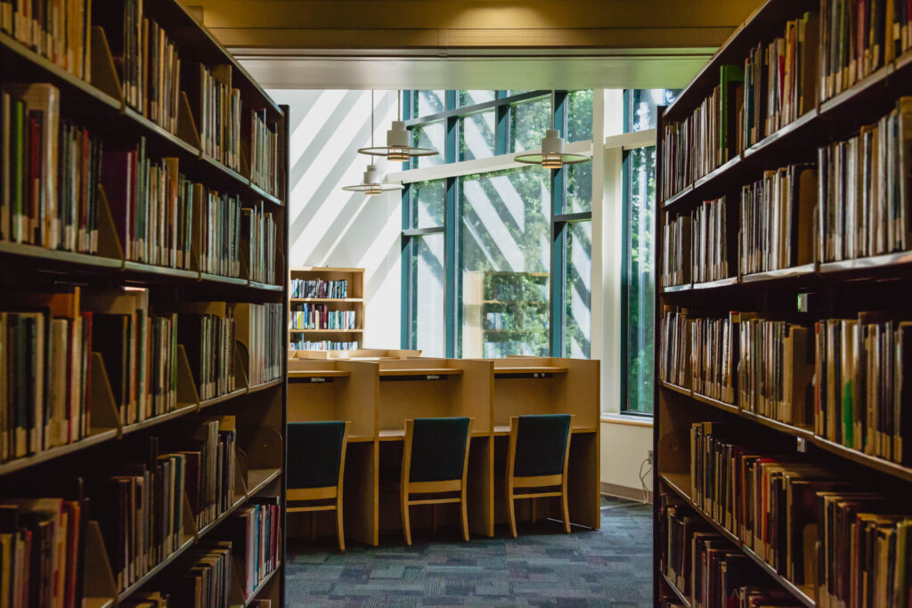 WSU Vancouver Library Archive | An interior view of library book stacks and rows of empty study desks at WSU Vancouver
