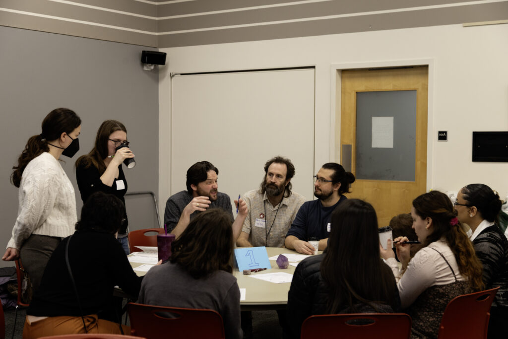 WSU Vancouver-Technical and Professional Writing | A small seminar style group discussion around a table inside a WSU Vancouver classroom