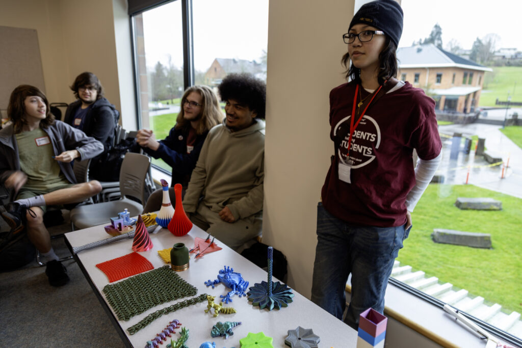 WSU Vancouver Library Event | Students working on creative crafts or art projects around a table inside a classroom workshop