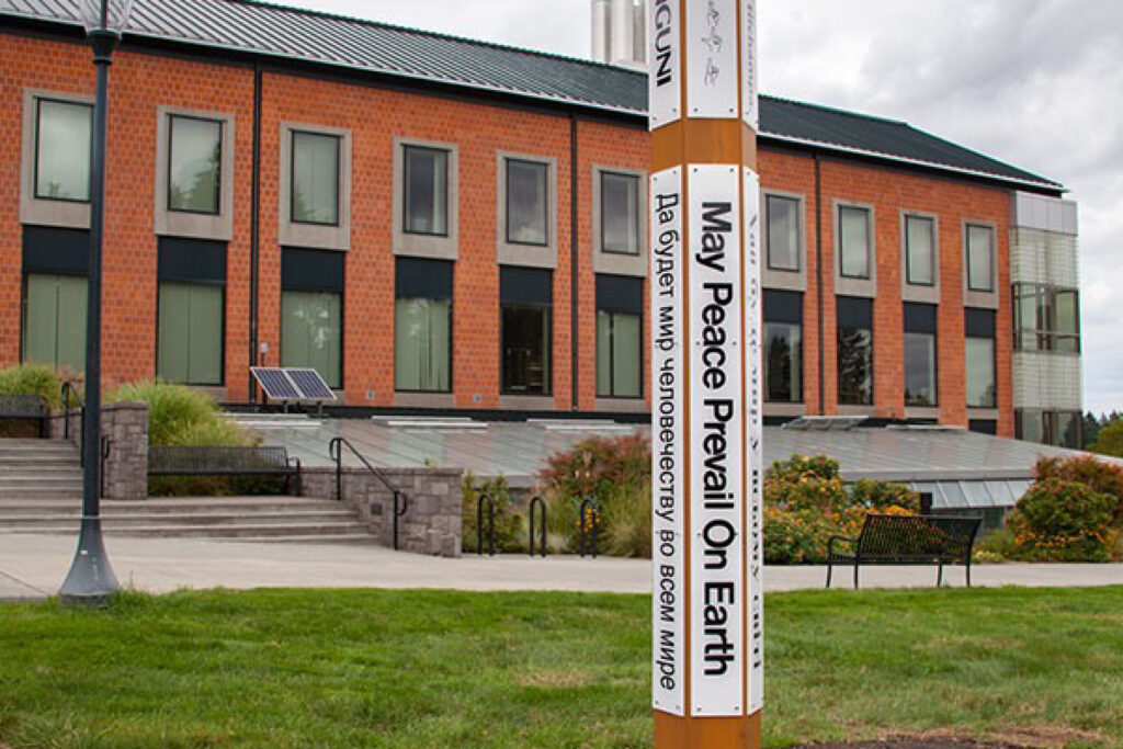 WSU Vancouver - Peace Pole - Art on Campus Exterior architecture view of a classic multi-story brick academic building at WSU Vancouver