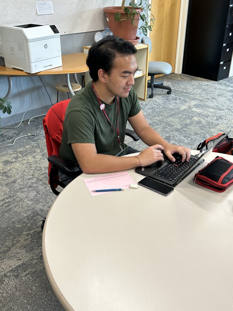 WSU Vancouver Writing Center A student focusing and working on a laptop computer inside an office or library study space