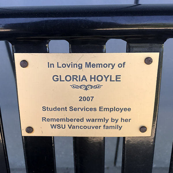 A bronze memorial plaque plate mounted on stone honoring Gloria Hoyle at WSU Vancouver