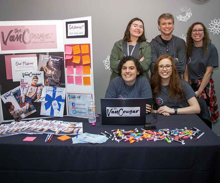 Student representatives managing an informational display table at a WSU Vancouver resource fair