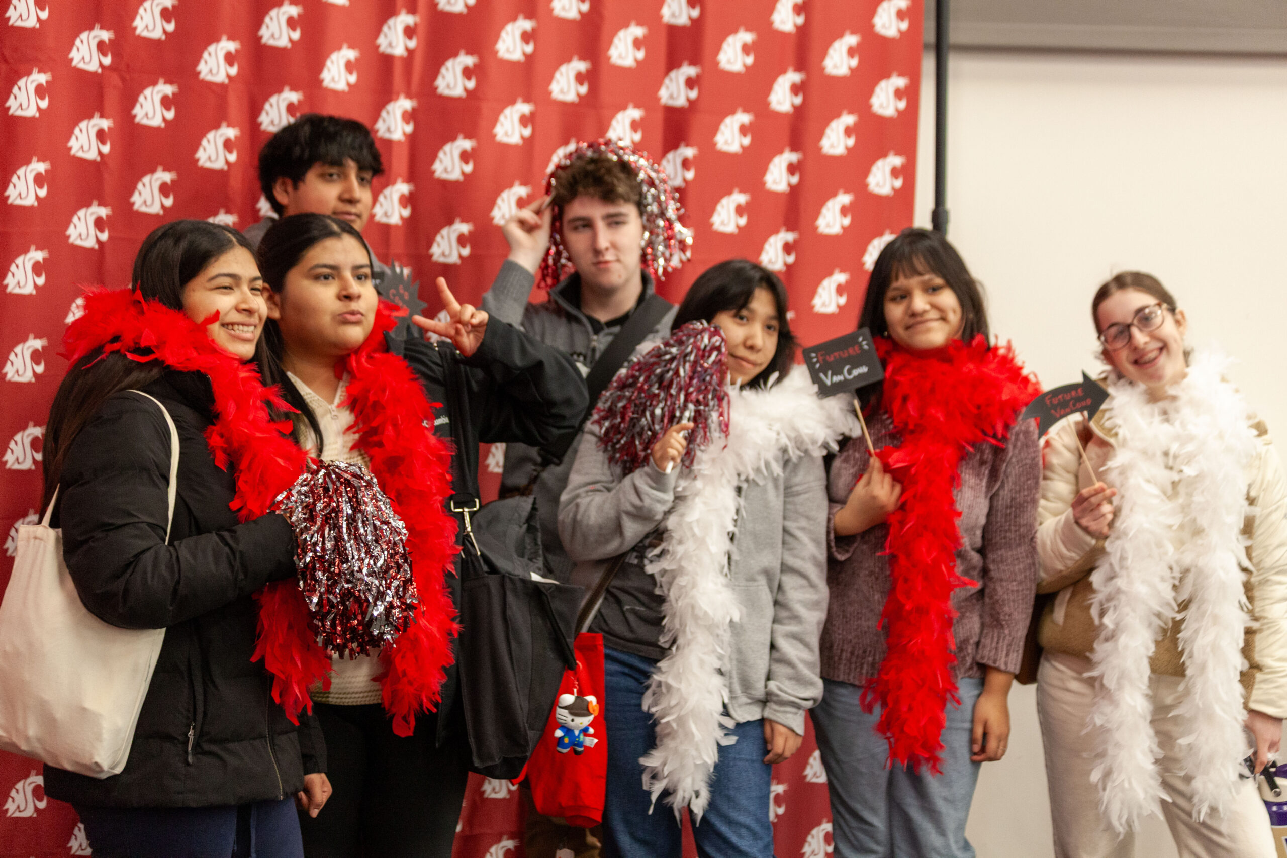 A group of people dressed in red winter jackets standing together outside