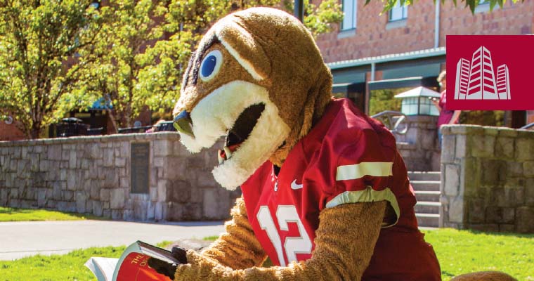 A playful photo of Butch, the WSU mascot, gesturing energetically at an outdoor campus festival