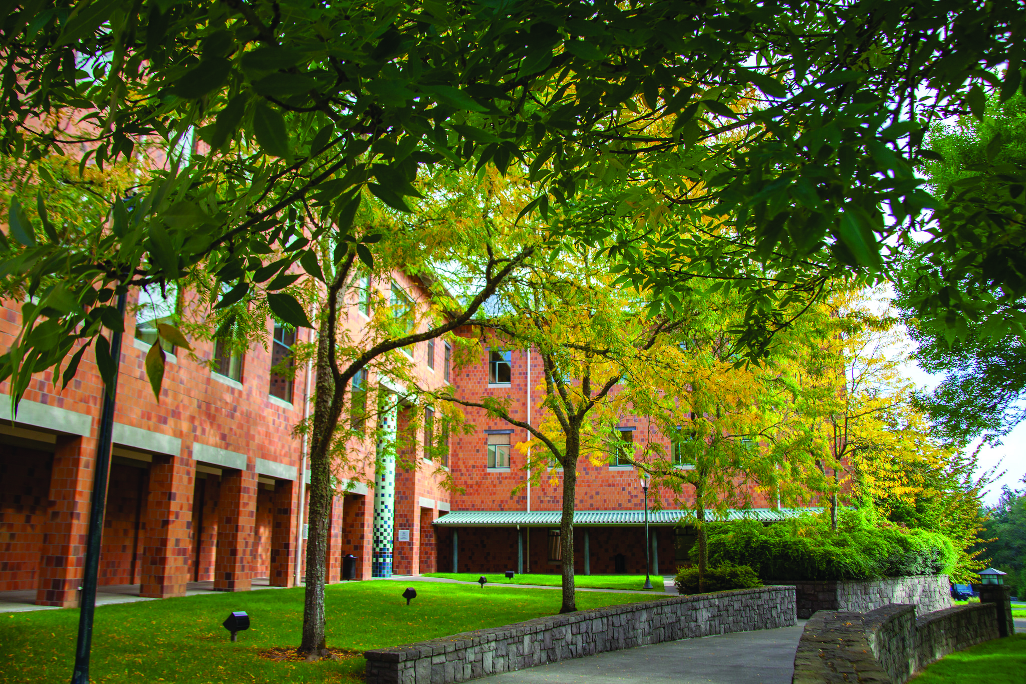 An exterior courtyard view of a classic multi-story academic brick building at WSU Vancouver