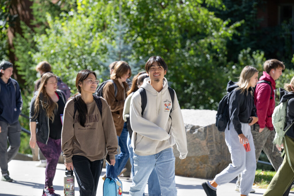 WSU Vancouver-Academic Complaint Procedures | Two students standing next to an outdoor handrail talking on the WSU Vancouver campus